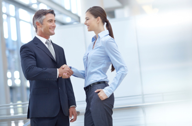 Businessman and -woman shaking hands